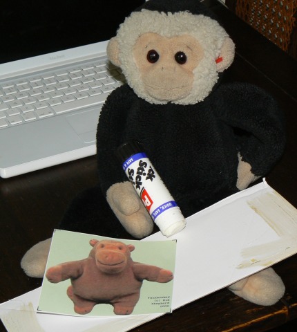 Mooch sticks his faux Mr Monkey to some card