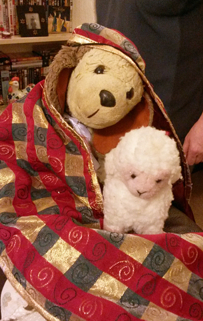 Snoozems the dog at Christmas with a lamb.