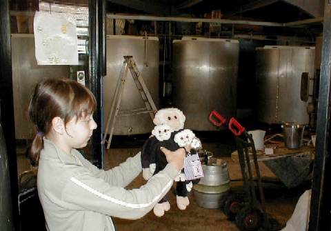 Annie holds Mooch outside the brewing area.