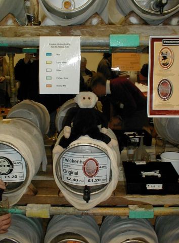 Mooch sits on one cask of beer.