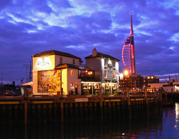 The Bridge Tavern, Portsmouth in the dusk showing the mural of Thomas Rowlandson's Portsmouth Point, with the Spinaker Tower in the background.