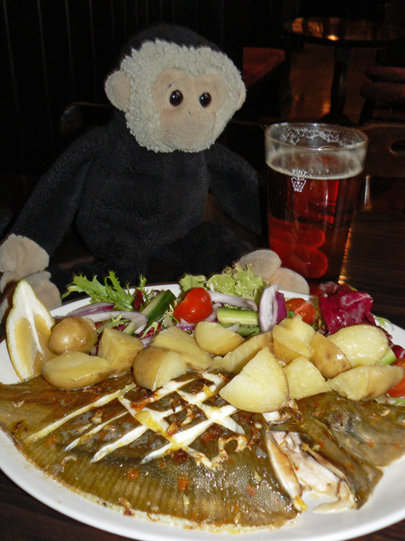Mooch monkey having fish for lunch at The Bridge Tavern, Portsmouth.