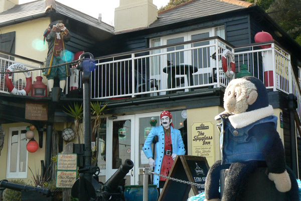 Mooch monkey sits outside the Spyglass Inn, Ventnor, Isle of Wight.