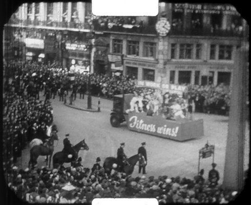 One of the floats at the 1938 Lord Mayors Show, at Ludgate Circus, London, showing a "Fitness Wins!" banner.