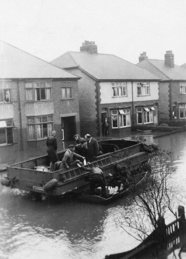 A DUKW delivering milk and food in Roland Avenue, Wilford, during the River Trent's flood. February 1946.