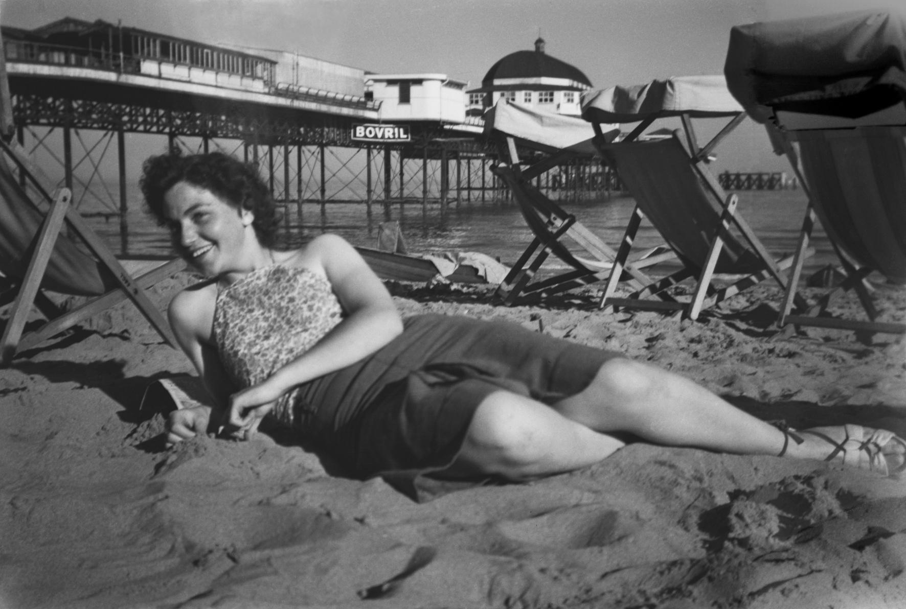 Una on the beach at Shanklin, Isle of Wight, with the pier behind. 1947.