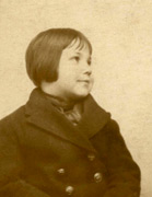 Me at 4 years old with short hair, in my navy reefer jacket which had brass buttons..