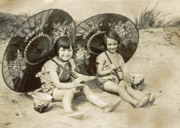 Myself and Eileen on the Mablethorpe beach with paper parasols.