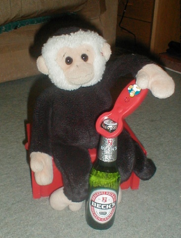 Mooch monkey using his favourite tool on a bottle of Becks.