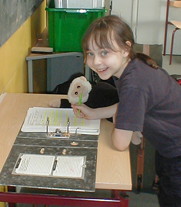 Mooch helps Annie sign out from school.