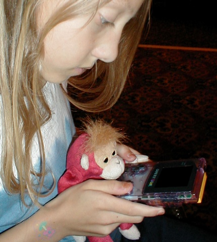 S1 plays on a Gameboy with Ellie.