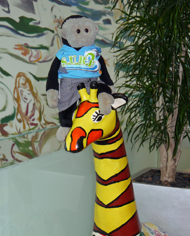 Mooch monkey sits on a giraffe at Stand Tall for Giraffes in Colchester 2013