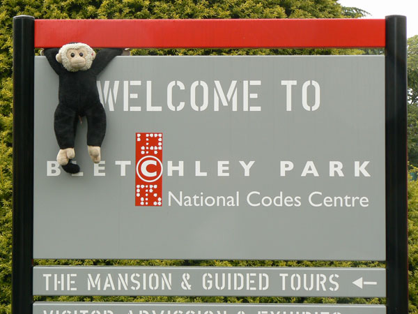 Mooch monkey hangs from the Bletchley Park sign.