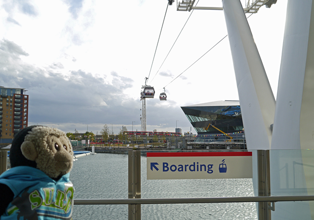 Mooch monkey uses the TfL Emirates Air Line cable car - cable car cabins at terminals