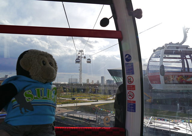 Mooch monkey uses the TfL Emirates Air Line cable car - passing another cable car cabin