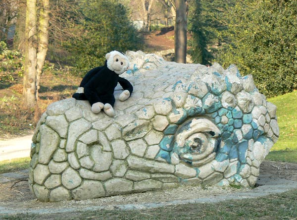 Mooch monkey rests on the head of a dinosaur in Crystal Palace Park.