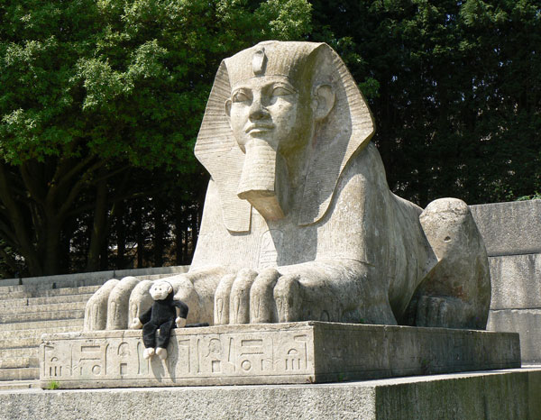Mooch monkey sits with a sphinx in Crystal Palace Park.