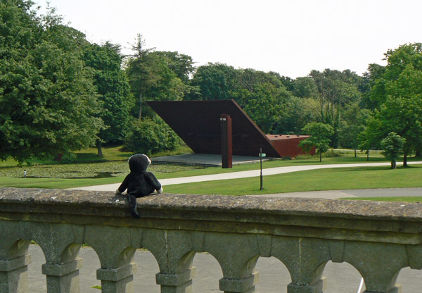 Mooch monkey looking towards the open air music stage in Crystal Palace Park.