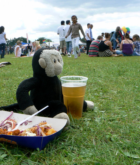 Mooch monkey eats a curry and drinks a beer at the Croydon Mela - August 2009.