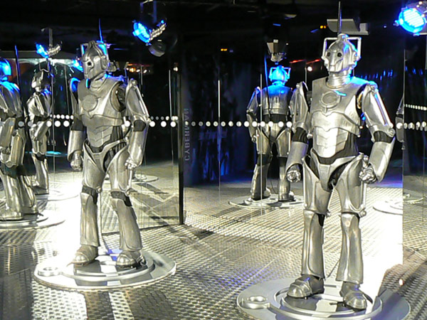 Two Cybermen from Doctor Who in a disco environment.