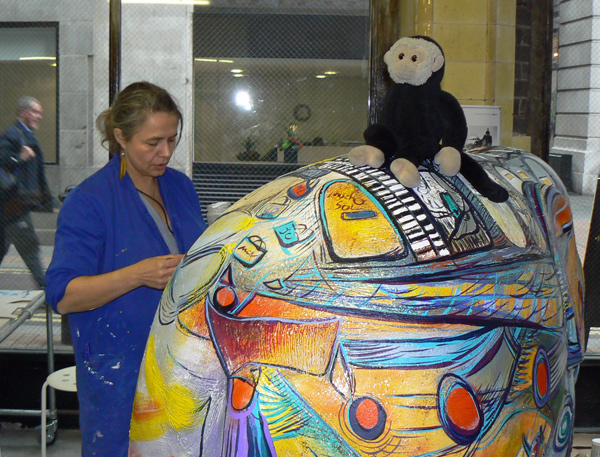 London Elephant Parade - Mooch monkey sits on an elephant being painted in the shop