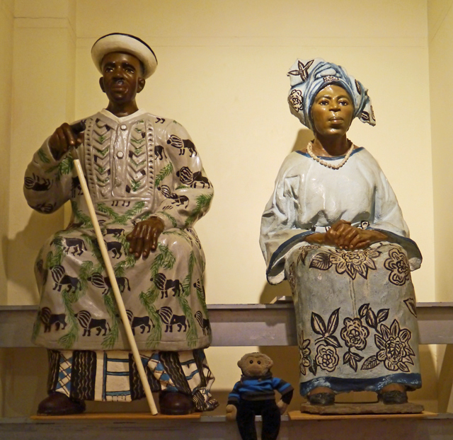 Mooch monkey with Ibibio Cement Sculptures at the Horniman Museum