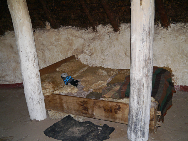 Mooch monkey at Butser Ancient Farm - bed inside an Iron Age building