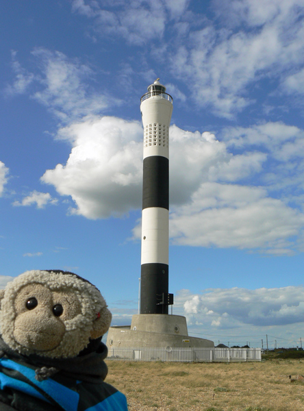 Mooch monkey in front of the new lighthouse on the Dungeness beach.