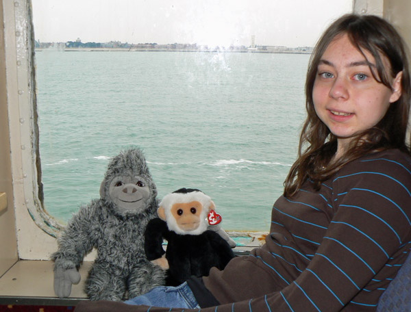 Annie and Mina monkey sit with Yeti in a ferry window.