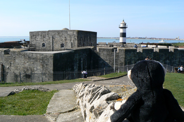 Monty Mooch monkey looks at Southsea Castle and lighthouse.