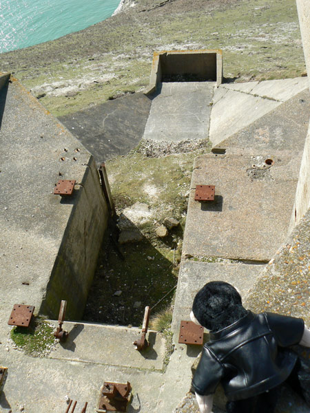 Monty Mooch monkey looks down into the remains of an exhaust pit at the New Battery rocket test site, Isle of Wight.