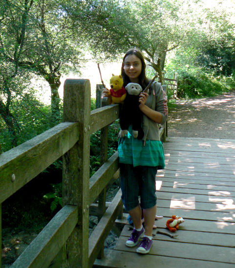 Annie with Pooh bear and Mooch monkey on Pooh Bridge playing Pooh Sticks.