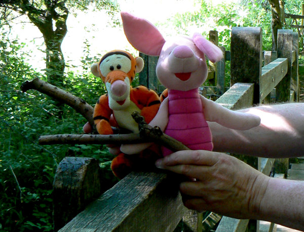Tigger and Piglet on Pooh Bridge playing Pooh Sticks.