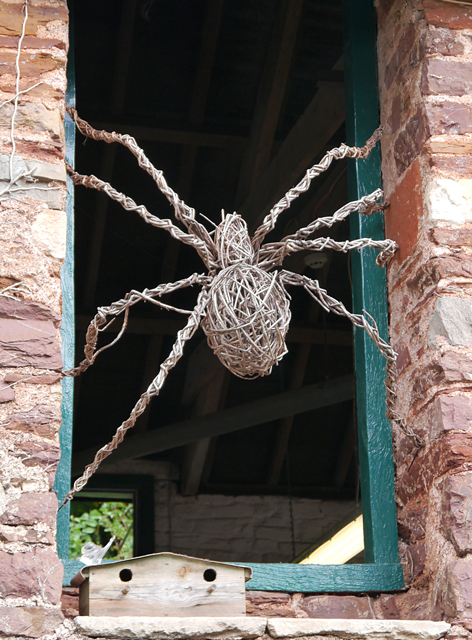 Mooch monkey - a spider sculpture in a window of the Cockington craft centre