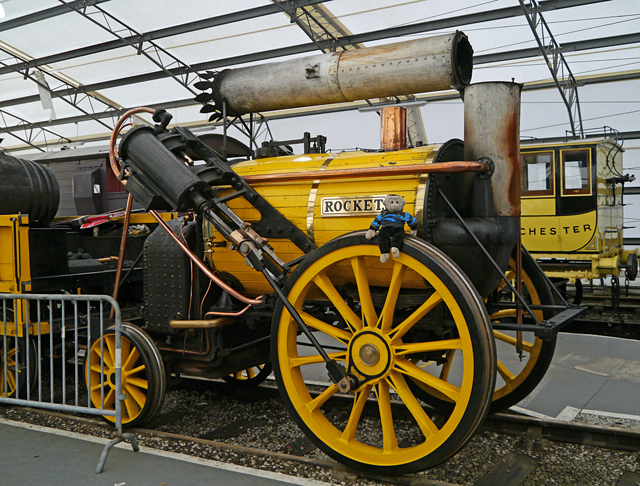 Mooch monkey sits on a Rocket replica steam engine at the Railway Museum in York